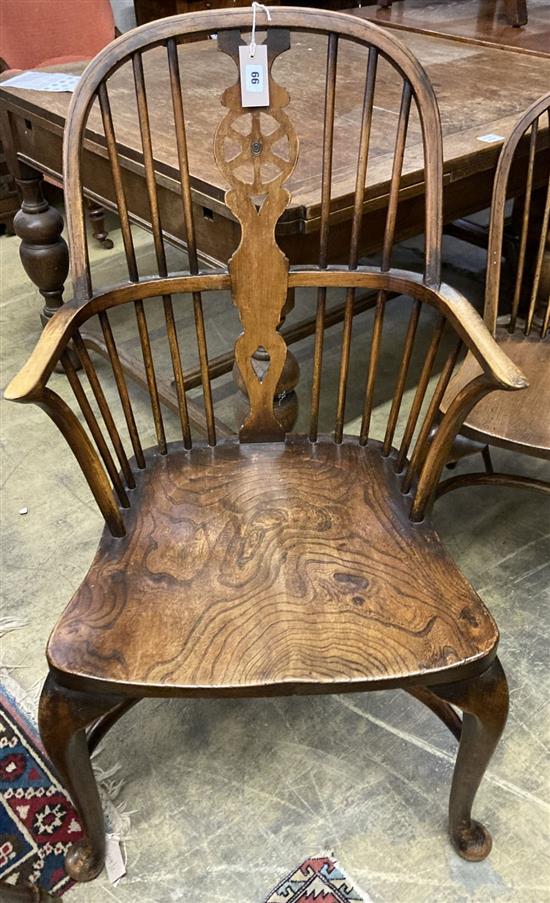 A set of eight early 20th century elm and beech Windsor wheelback dining chairs, with crinoline stretchers (two with arms)